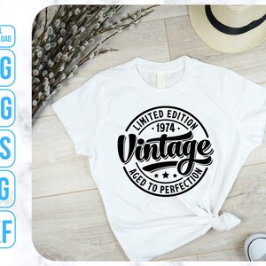 May include: White t-shirt with a black circle graphic that says "Limited Edition 1974 Vintage Aged to Perfection".