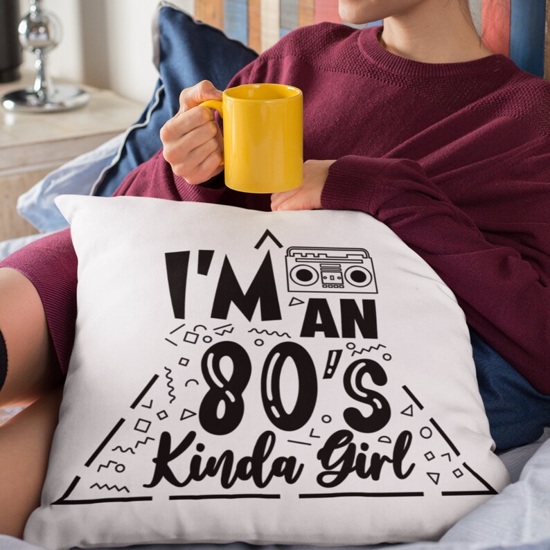 May include: White throw pillow with black text that reads "I'm an 80's Kinda Girl" with a retro cassette player graphic.