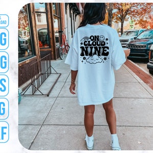 May include: White t-shirt with black text that reads "On Cloud Nine" with a cloud and stars graphic.