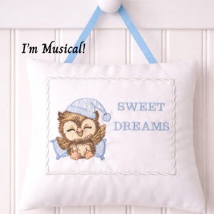 May include: White square pillow with an embroidered owl wearing a blue nightcap, resting on a blue pillow. The text "SWEET DREAMS" is embroidered in blue. The text "I'm Musical!" is printed on the top left.