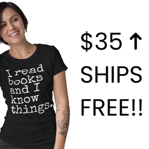 A smiling woman wearing a black t-shirt with the text "I read books and I know things" printed on it.