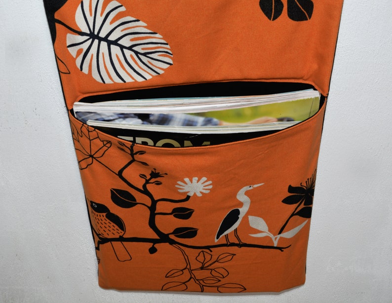 Wall utensil for magazines Mrs Knallerbse The orange wall organizer with birds and branches creates storage space in the office image 4