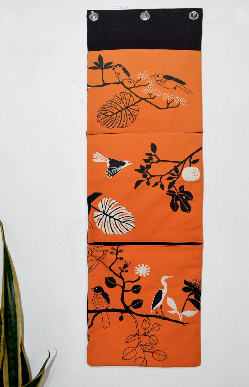 Wall utensil for magazines Mrs Knallerbse The orange wall organizer with birds and branches creates storage space in the office image 2