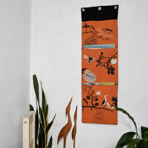 Wall utensil for magazines Mrs Knallerbse The orange wall organizer with birds and branches creates storage space in the office image 1