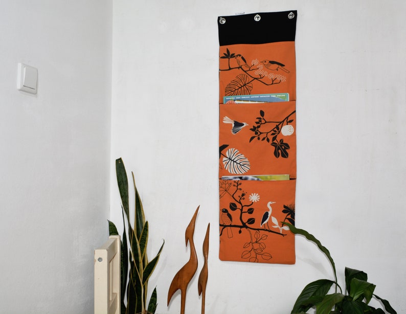 Wall utensil for magazines Mrs Knallerbse The orange wall organizer with birds and branches creates storage space in the office image 1