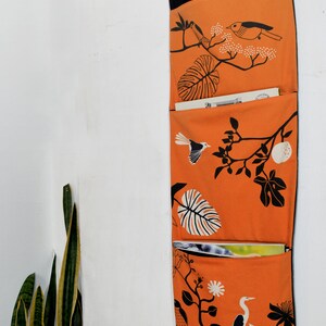 Wall utensil for magazines Mrs Knallerbse The orange wall organizer with birds and branches creates storage space in the office image 7