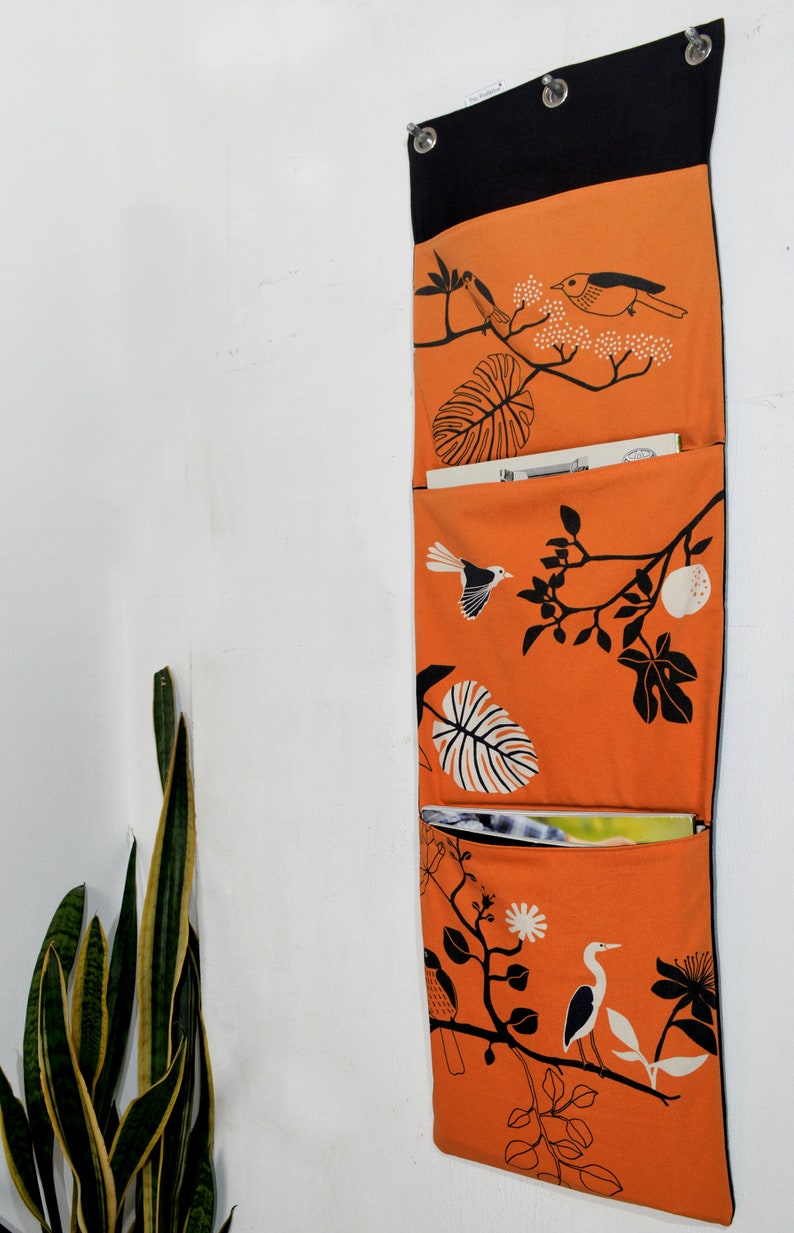 Wall utensil for magazines Mrs Knallerbse The orange wall organizer with birds and branches creates storage space in the office image 7