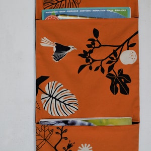 Wall utensil for magazines Mrs Knallerbse The orange wall organizer with birds and branches creates storage space in the office image 3