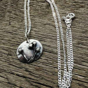 embossed silver nature pendant