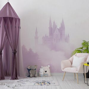 May include: A purple canopy tent with tassels hangs in a room with a pink and white castle mural on the wall. A pink armchair with a white pillow sits in front of the mural. Two stuffed animals sit on the floor in front of the tent.
