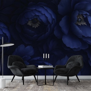 May include: Two black armchairs with a dark blue floral wallpaper background. The chairs are positioned in front of a coffee table with a white square object on top.