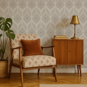 May include: A mid-century modern living room scene featuring a patterned armchair with a rust-colored pillow. A wooden cabinet with a brass lamp and books sits beside the chair. The background has a gray and white patterned wallpaper, and a potted plant is on the left.