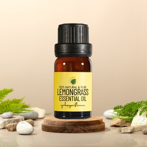 May include: A small amber glass bottle with a black lid, containing lemongrass essential oil. The bottle is labelled "100% Natural & Pure Lemongrass Essential Oil cymbopogon flexuosus".