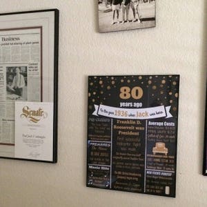 May include: A black and gold 80th birthday sign with gold glitter and confetti. The sign says "80 years ago in the year 1936 when Jack was born". The sign also includes information about pop culture, premieres, music hits, and average costs in 1936.