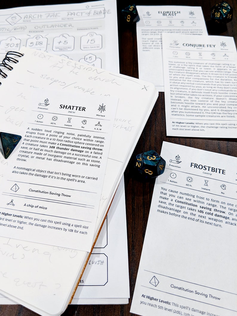 May include: A close-up of a Dungeons and Dragons rulebook open to the Shatter spell description. The spell description includes the spell's name, a description of the spell's effects, and the Constitution saving throw required to resist the spell's effects. The image also includes a few dice, including a blue and green d6 die.