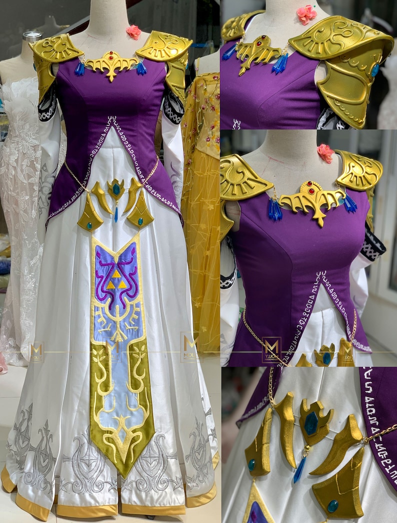 May include: A white and purple dress with gold accents and a blue and gold design. The dress has a long skirt and a fitted bodice. The dress is decorated with a gold chain and a gold pendant.