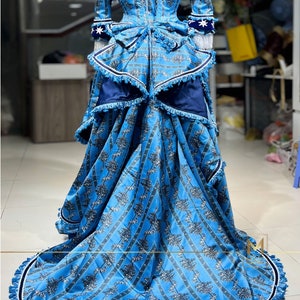 May include: A blue and white patterned dress with a long skirt and a fitted bodice. The dress has a white lace trim and a blue sash. The skirt is full and flowing, and the dress is perfect for a formal occasion.