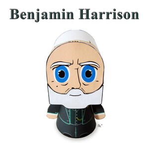 May include: Papercraft figurine of Benjamin Harrison, the 23rd President of the United States. The figurine is depicted with a white beard, blue eyes, and is wearing a dark green suit.