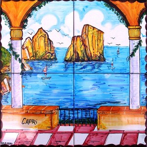 May include: A hand-painted ceramic tile mural depicting a view of the sea from a balcony with a stone archway and columns. The scene features two rocky islands in the distance, a blue sea with sailboats, and the word "CAPRI" written on a wall.