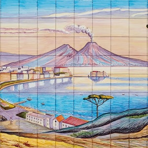 May include: A colourful ceramic tile mural depicting a cityscape with a volcano in the background. The scene includes a body of water, buildings, trees, and figures. The tile is divided into a grid pattern.