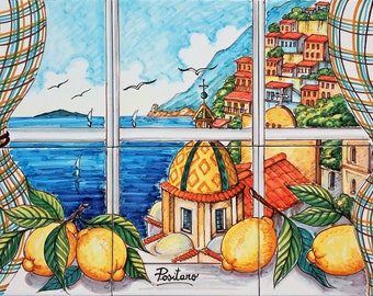 May include: A colorful ceramic tile depicting a window view of a seaside town with a church dome, blue water, and sailboats. The window is framed by a plaid curtain and a lemon tree with yellow lemons.