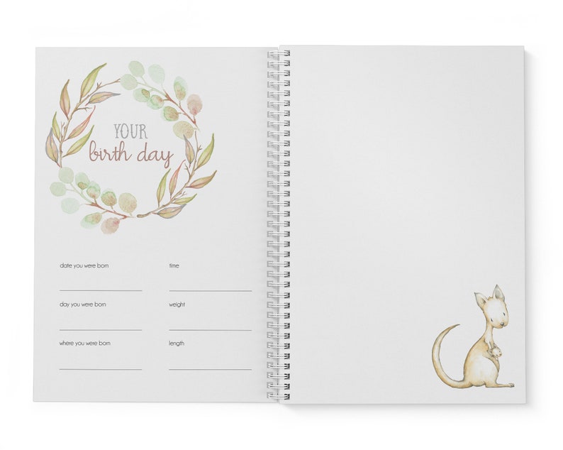 May include: A white spiral bound journal with a watercolor illustration of a wreath of leaves and the text "YOUR birth day". The journal has sections for recording the date, time, day, weight, and length of a baby's birth. The opposite page features a watercolor illustration of a kangaroo.