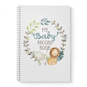 Puede incluir: Una libreta blanca de espiral con una ilustraci&oacute;n de acuarela de una corona de hojas con un elefante y un le&oacute;n. El texto "My Baby Record Book" est&aacute; en el centro de la corona.