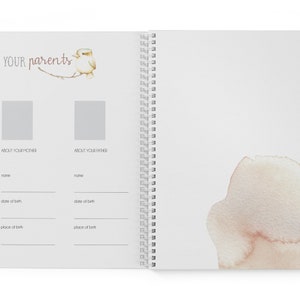 May include: A white spiral bound journal with a watercolor design on the cover. The front cover has the text "YOUR parents" and a small bird illustration. The inside pages have sections for "About Your Mother" and "About Your Father" with lines for writing names, dates of birth, and places of birth.