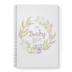 May include: A white baby book with a watercolor wreath of leaves and flowers. The text "My Baby Book" is in the center of the wreath. A kangaroo and a koala are inside the wreath.