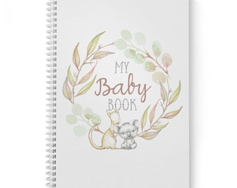 Può includere: Un libro bianco per bambini con una ghirlanda ad acquerello di foglie e fiori. Il testo "My Baby Book" è al centro della ghirlanda. Un canguro e un koala sono all'interno della ghirlanda.