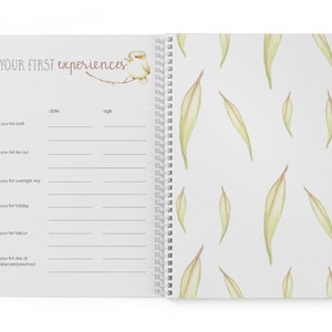 May include: A white journal with a spiral binding and a watercolor illustration of a bird on a branch. The cover has the text "YOUR FIRST experiences" and the inside pages have headings for "date" and "age" with lines for writing.