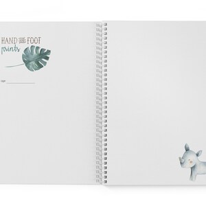 Puede incluir: Un cuaderno blanco de espiral con una hoja verde y el texto "HAND and FOOT prints" en la portada. La contraportada tiene una ilustraci&oacute;n de acuarela de un rinoceronte gris.