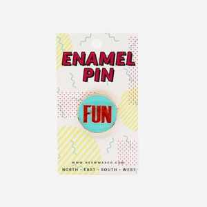 May include: A blue and red enamel pin with the word "FUN" on it. The pin is on a white card with yellow and red stripes and the words "ENAMEL PIN" and "WWW.NESWAXCO.COM".