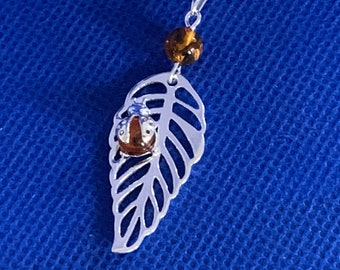Filigree leaf pendant with amber cabouchon lady bird and snake chain sterling silver