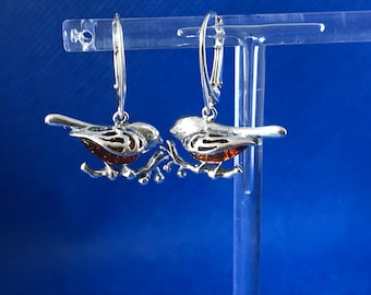 Robin amber  and sterling silver .925 sitting on a branch