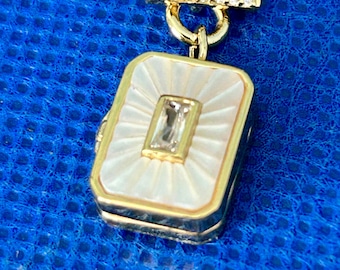 Locket, mother of pearl Czs ,sterling silver with gold over lay,hinged snap fastener, 40cms plus 3 cms  delicate beautiful Art Deco in style