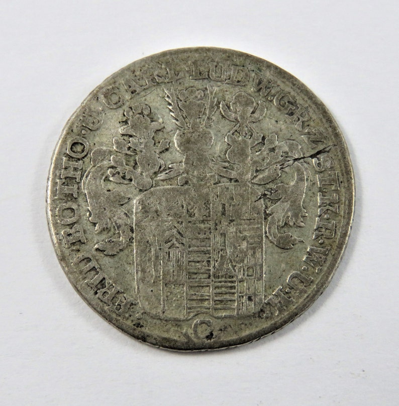 German States-Stolberg-Stolberg 1763 C Silver 1/6th Thaler Coin. This Coin has a Die Break shops around the 2 o'clock area which is a crack.