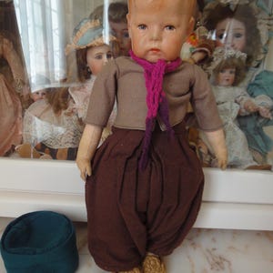 One antique Kathe Kruse doll 1 wide hips dated about 1925 old clothes beautiful face old Kruse doll