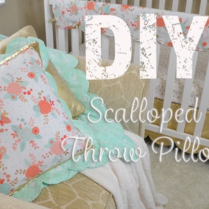 May include: DIY Scalloped Throw Pillow with a floral pattern and a mint green scalloped edge. The pillow is sitting on a couch with a white blanket.