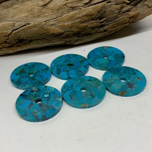 About 2.5mm thick x 25mm wide Turquoise Hole is 3.5mm TP675