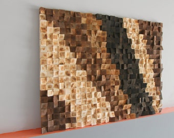 May include: A wall-mounted acoustic panel made of wood blocks in shades of brown and beige. The blocks are arranged in a staggered pattern, creating a textured surface.