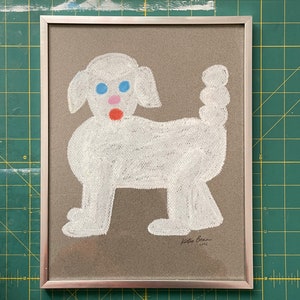 May include: A framed drawing of a white dog with blue eyes and a red nose on a brown background. The drawing is signed "Katie Bean 2021".