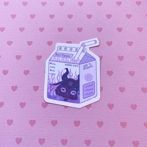 May include: A milk carton-shaped sticker with the text "Hell flavor". It features a purple illustration of a horned creature, flames, and the text "Made with Real souls". The sticker also says "100% Organic".