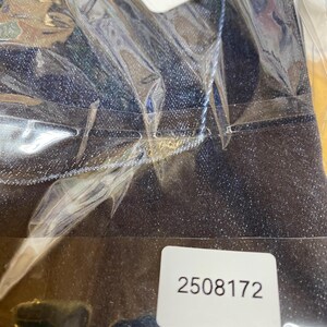 May include: Dark blue denim trousers in a clear plastic bag. A white tag with the text "Anthro Stretch" is visible. A white sticker with the number "2508172" is also visible.