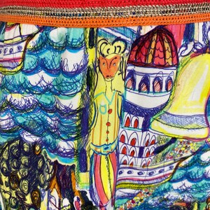 May include: Close-up of a vibrant fabric with a detailed illustration. The design features a whimsical cityscape with figures, buildings, and water elements in shades of blue, yellow, and red. The top edge has a decorative trim with green, orange, and gold accents.