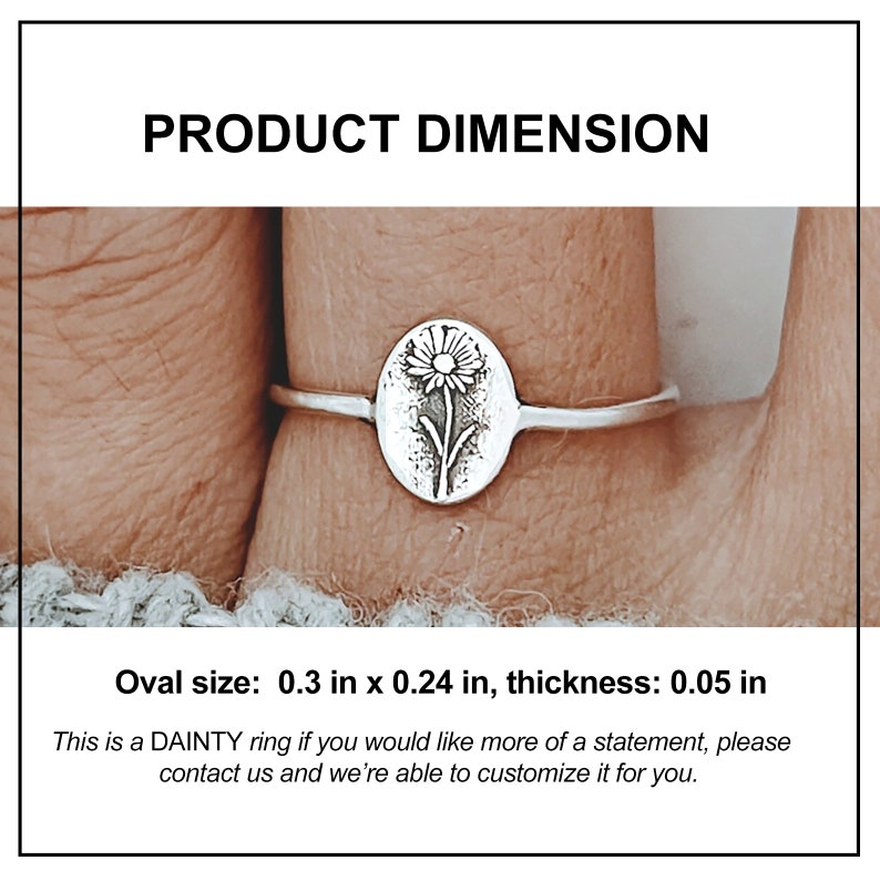 May include: A silver ring with an oval pendant displaying a floral design. The oval pendant is 0.76 cm by 0.61 cm, with a thickness of 0.13 cm. The text "PRODUCT DIMENSION" is at the top. The ring is shown on a finger.