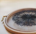 Hand Embroidered Black Dandelion – Boho Wall Art on Tulle – Modern Embroidery Hoop Decor (5") product logo
