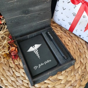 Gepersonaliseerd dagboek-notebook als cadeau voor dokter, speciaal tandartscadeau als houten kist. Gepersonaliseerde notebook en pen cadeauset.