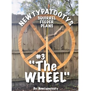 May include: A wooden squirrel feeder plan, titled "The Wheel," is displayed against a wooden fence. The design features a large, circular wooden frame with intersecting supports. The text "NEWTYPATOOTYS" and "SQUIRREL FEEDER PLANS" are above the wheel, with "#3" and "The Wheel" below.