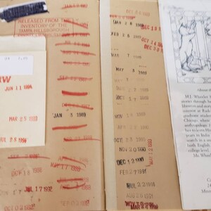 May include: A close-up of a book's back cover with a red stamp that says "Released from the Inventory of the Tampa Hillsborough County Library System". The book's title is "About the Author" and the text describes the author's interest in storytelling and her studies in anthropology. The book is published by Carolrhoda Books, Inc. 241 First Avenue North Minneapolis, Minnesota 55401.